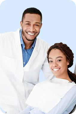 Dentist and female patient smiling together in dental office