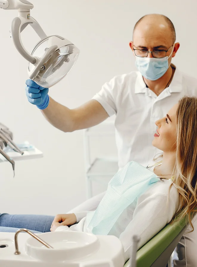 Dentist preparing patient for treatment in modern dental office