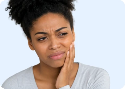 Woman touching her cheek with a pained expression